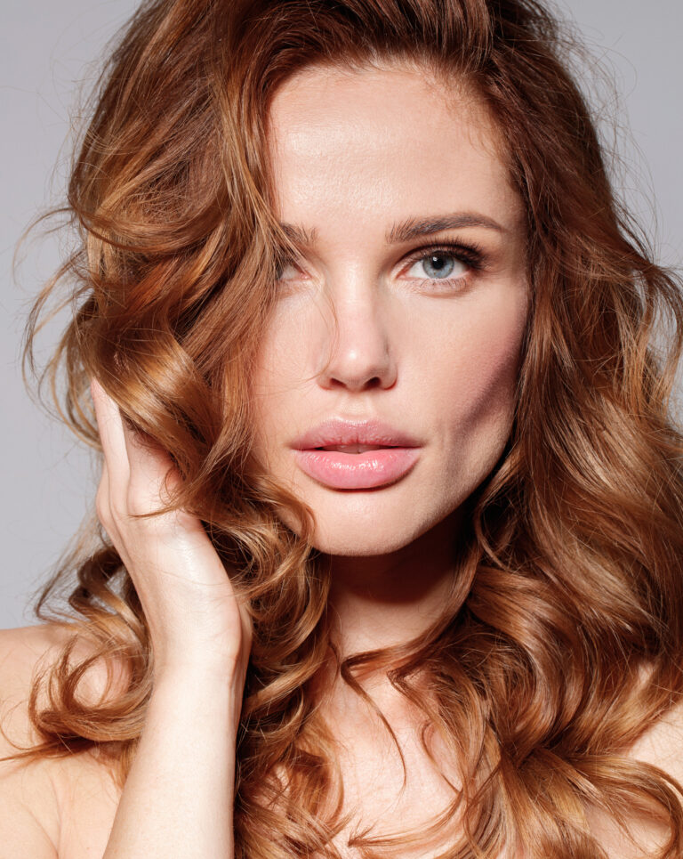 Woman with natural make up and curly long hair